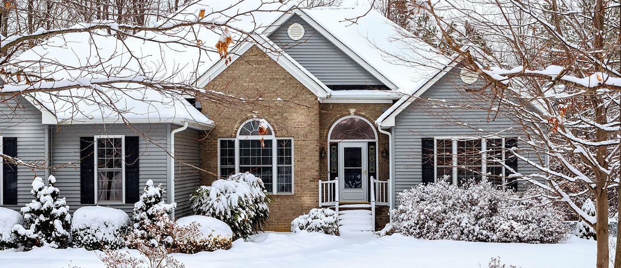 Snow-covered windows on a home exterior illustrating winter conditions and the need for high-performance insulated windows