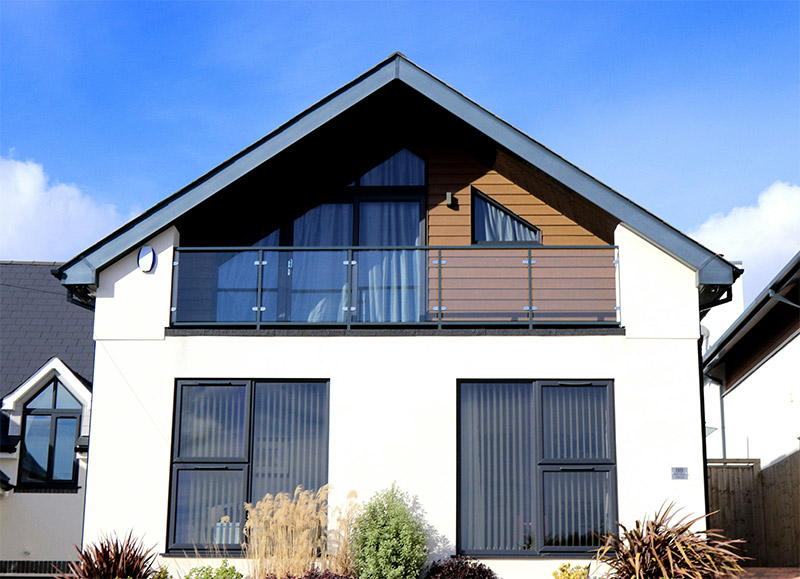 Luxury house exterior with large modern windows illustrating factors homeowners consider when choosing new window frames
